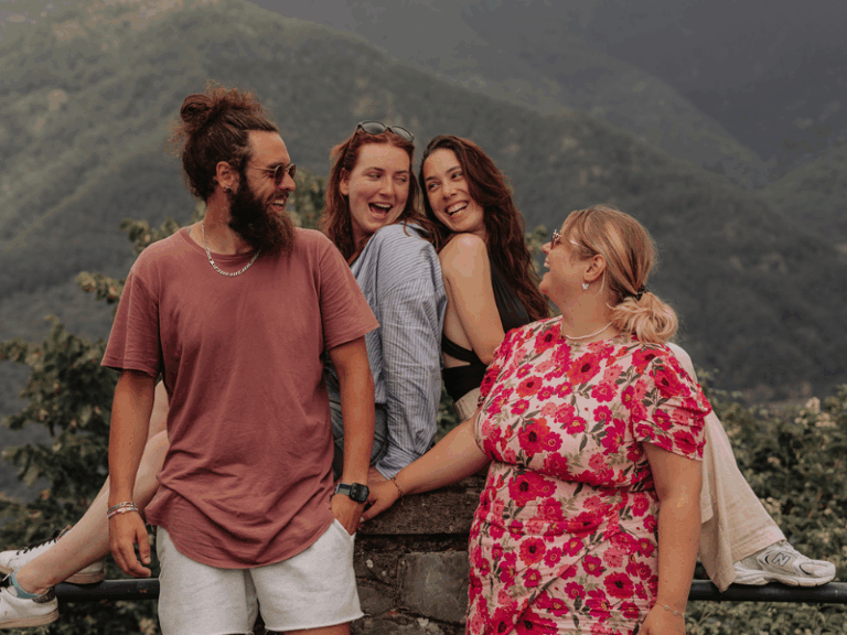 Familie, die zusammen für ein Foto in der Toskana lacht.