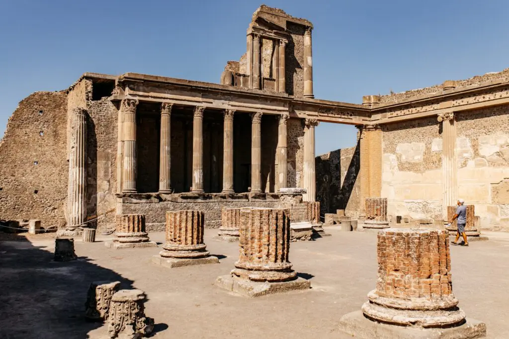 ancient Roman ruins of Pompeii with a person walking