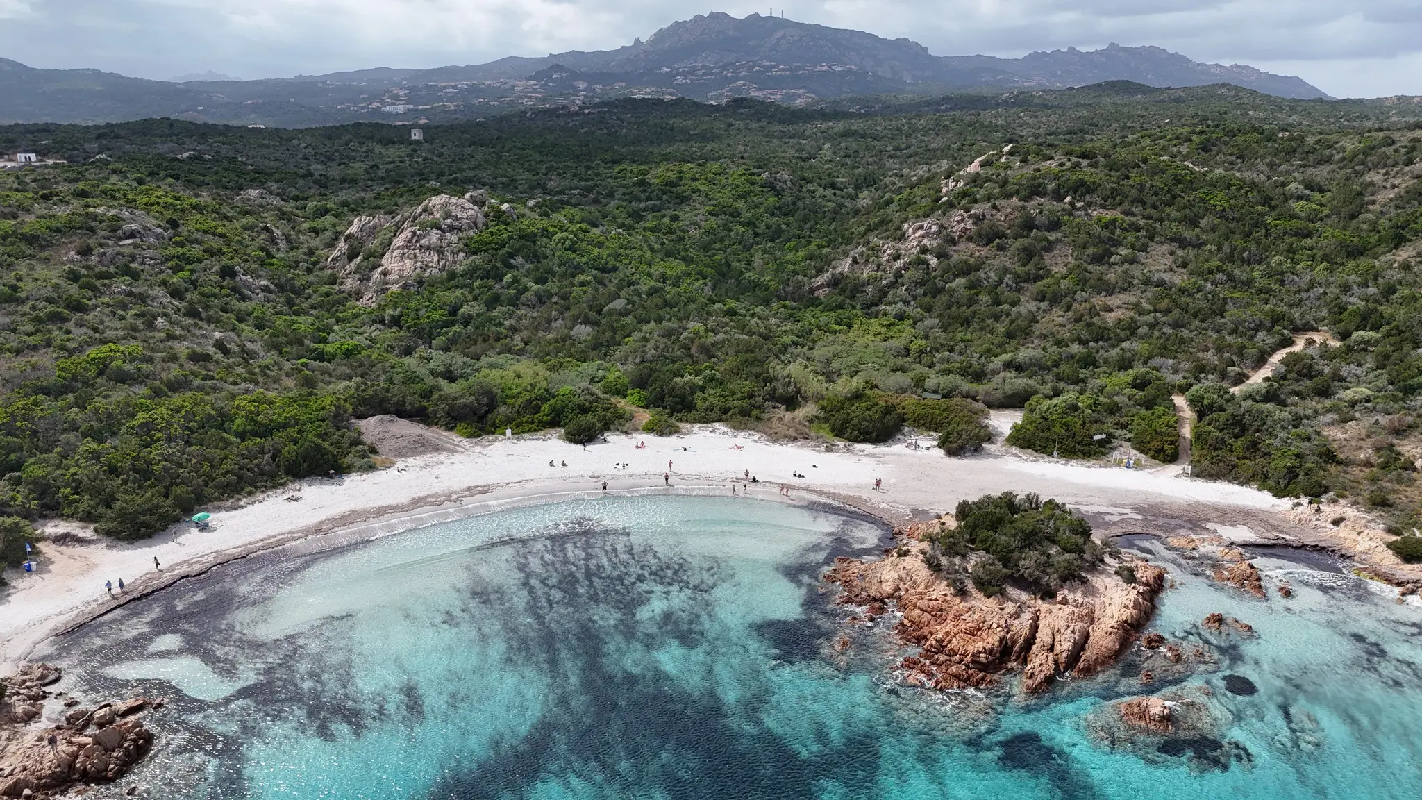 drone view of a white sand beach with clear turquoise water