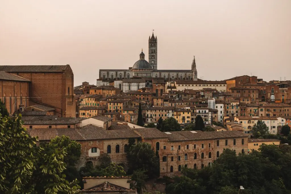 siena cityscape with duomo and historic buildings at sunset