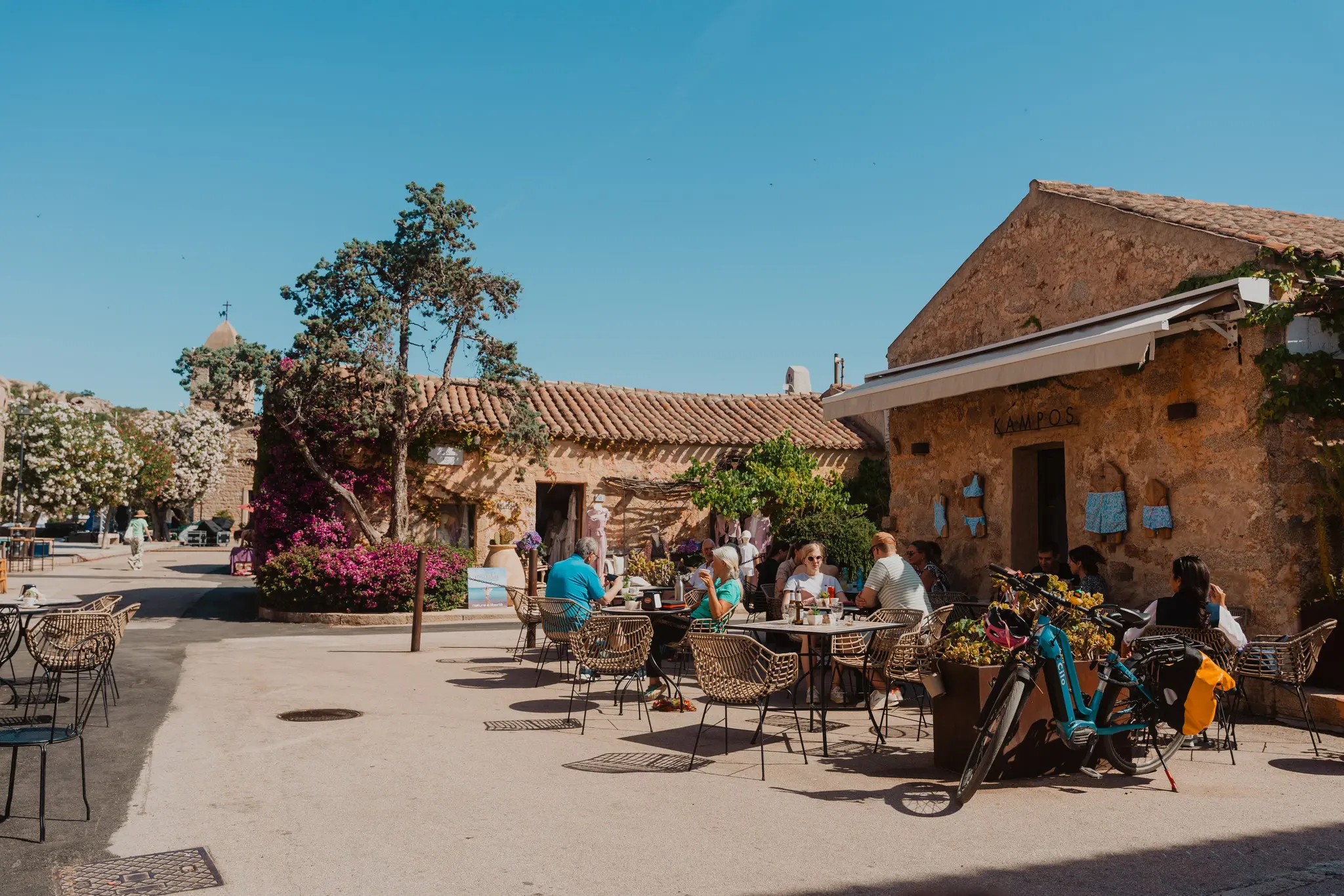 people dining outdoors at a cafe in Sardinia village