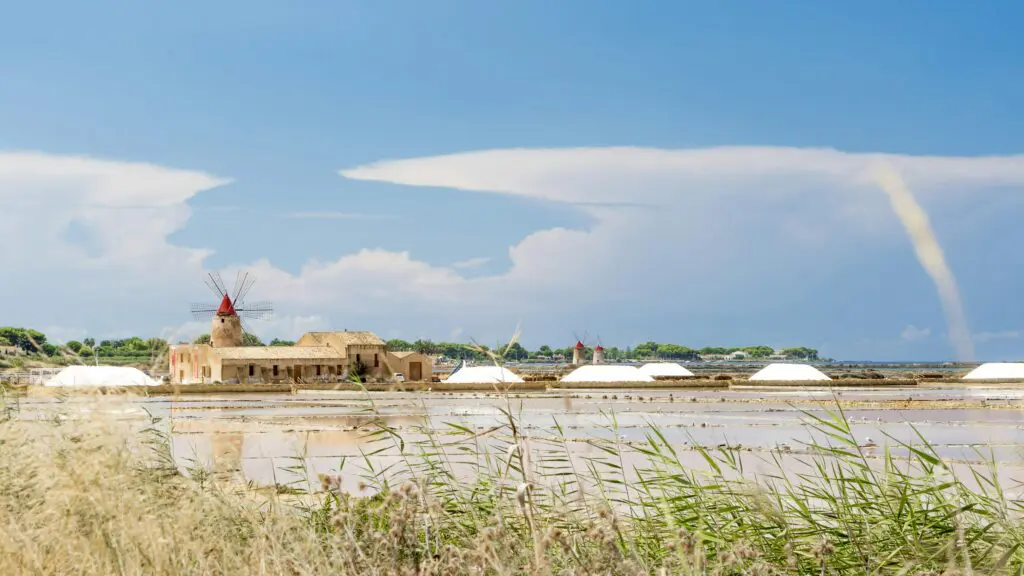 brown house beside body of water during daytime
