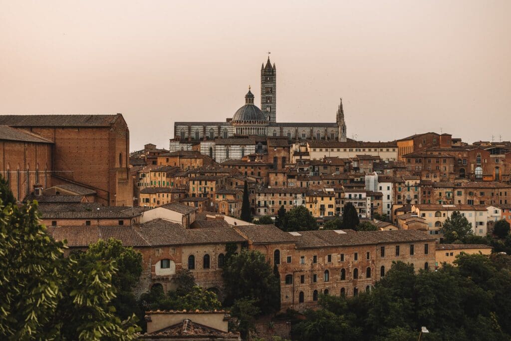 siena cityscape with duomo and historic buildings at sunset