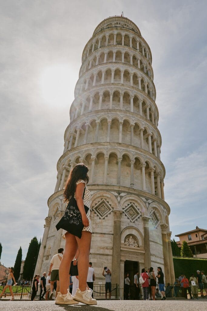 woman looking at the Leaning Tower of Pisa, Italy